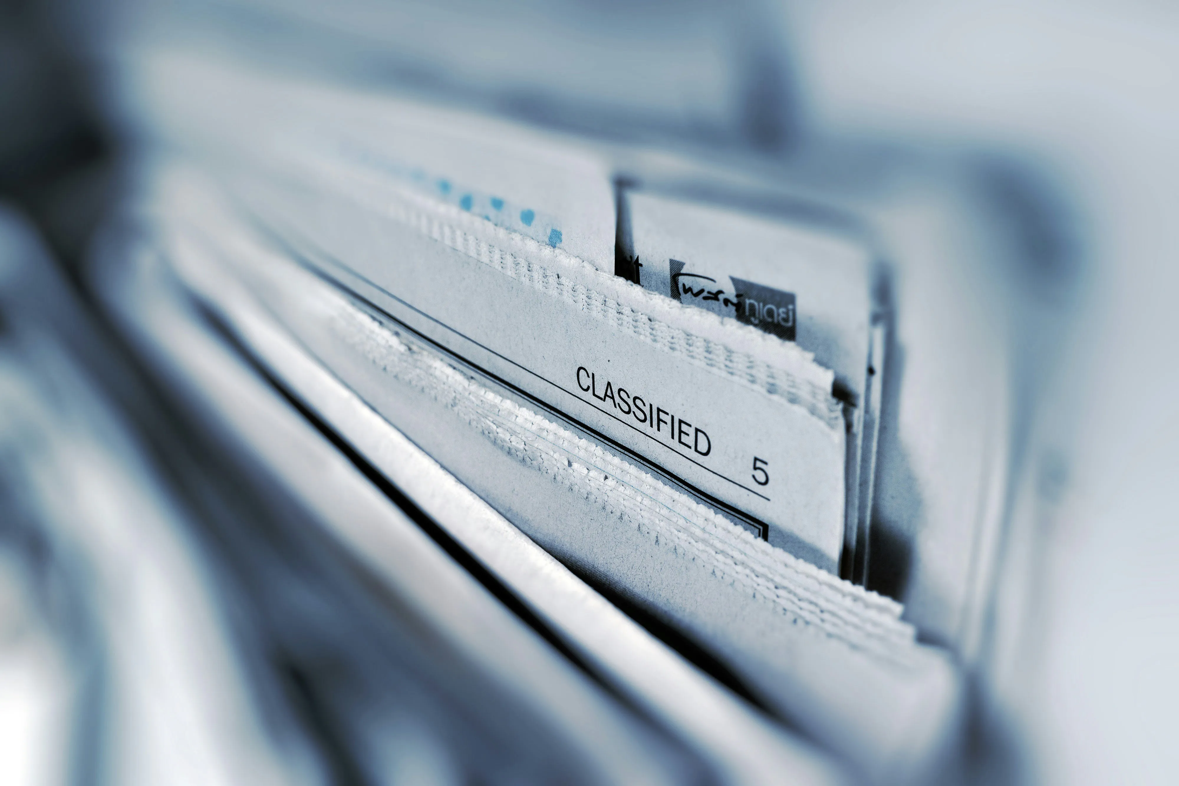 Classified page of a black and white newspaper, selective focus